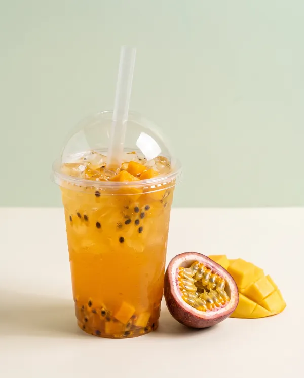 Iced mango and passion fruit tea with a halved passion fruit